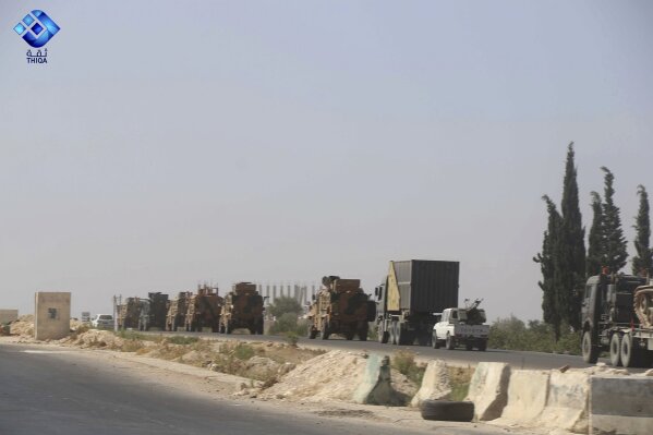 This photo provided by the activist-operated Thiqa News Agency, shows a Turkish military convoy heading toward the town of Khan Sheikhoun, in Idlib province, Syria, Monday, Aug. 19, 2019. The Turkish military convoy carrying ammunition crossed into northern Syria Monday and moved south through rebel-held areas before it was stopped by airstrikes that struck near the highway where the convoy was moving, opposition activists said. (Thiqa News Agency via AP)