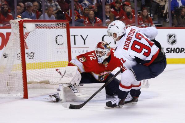Washington Capitals center Evgeny Kuznetsov (92) scores against Florida Panthers goaltender Sergei Bobrovsky (72) during the third period of Game 1 of an NHL hockey first-round playoff series Tuesday, May 3, 2022, in Sunrise, Fla. (AP Photo/Reinhold Matay)