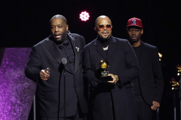 Killer Mike, left, accepts the award for best rap performance for "Scientists & Engineers" during the 66th annual Grammy Awards on Sunday, Feb. 4, 2024, in Los Angeles. (AP Photo/Chris Pizzello)