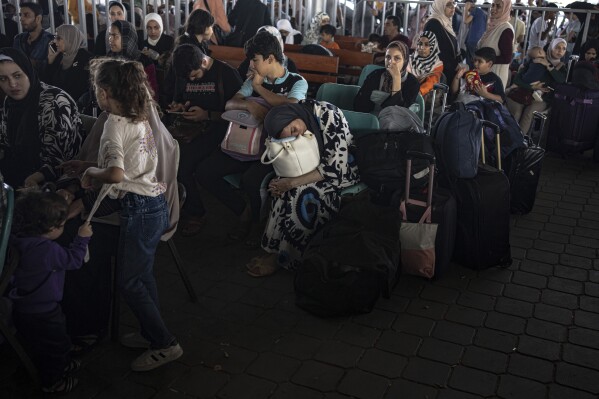 Palestinians wait to cross into Egypt at Rafah, Gaza Strip, on Wednesday, Nov. 1, 2023. (AP Photo/Fatima Shbair)