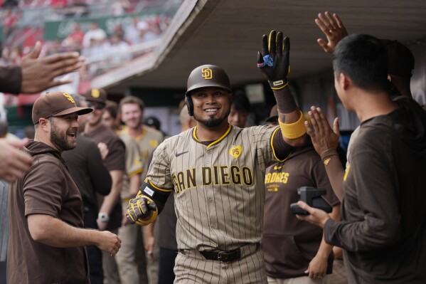 San Diego Padres' Luis Arraez is congratulated in the dugout after his home run against the Cincinnati Reds during the first inning of a baseball game Wednesday, May 22, 2024, in Cincinnati. (AP Photo/Carolyn Kaster)