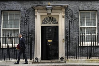 FILE - Britain's Prime Minister Rishi Sunak leaves 10 Downing Street to go to the House of Commons for his weekly Prime Minister's Questions in London, Wednesday, Feb. 28, 2024. The United Kingdom is poised to hold its first election in five years in a country battered by a cost-of-living crisis, fallout from the Israel-Hamas conflict and deep divisions over how to deal with migrants and asylum seekers crossing the English Channel from Europe on small inflatable boats. (AP Photo/Alastair Grant, File)