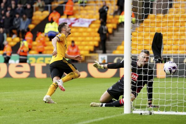 Wolverhampton Wanderers' Pablo Sarabia, left. celebrates after scoring his side's first goal of the game , during the English Premier League soccer match between Wolverhampton Wanderers and Sheffield United, at Molineux Stadium, in Wolverhampton, England, Sunday, Feb. 25, 2024. (David Davies/PA via AP)