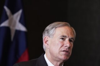 FILE - In this Wednesday, March 17, 2021, file photo, Texas Gov Greg Abbott speaks during a news conference about migrant children detentions, in Dallas. Texas child welfare officials say they've received three reports of abuse and neglect at a San Antonio coliseum that is holding more than 1,600 immigrant teenagers who crossed the southern border. Child welfare officials would not reveal details about who made the allegations, but Abbott said his understanding was that they came from someone who had been inside the facility. One of the allegations include sexual abuse, but no further details were provided. (AP Photo/LM Otero, File)