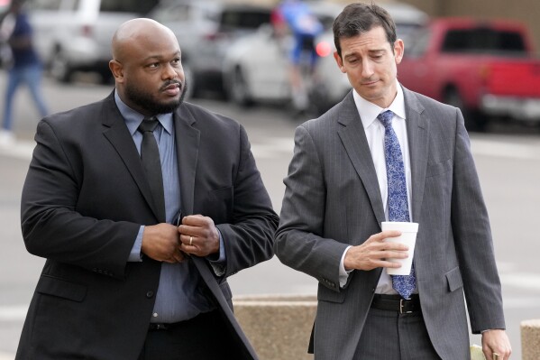 Former Memphis police officer Desmond Mills, left, arrives at the federal courthouse with his attorney Blake Ballin, right, to testify against his former colleagues during the trial in the Tyre Nichols case Wednesday, Sept. 25, 2024, in Memphis, Tenn. (AP Photo/George Walker IV)