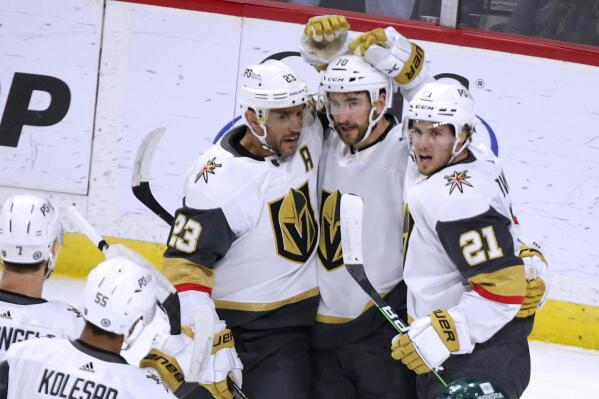Vegas Golden Knights center Nicolas Roy (10) is congratulated on his goal by Alec Martinez (23) and Brett Howden (21) during the first period of an NHL hockey game Thursday, Feb. 9, 2023, in St. Paul, Minn. (AP Photo/Andy Clayton-King)