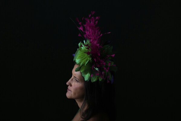A race fan walk through a tunnel at Churchill Downs before the 151st running of the Kentucky Oaks horse race Friday, May 2, 2025, in Louisville, Ky. (AP Photo/Brynn Anderson)