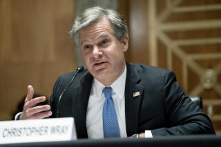 FBI Director Christopher Wray testifies before a Senate Homeland Security and Governmental Affairs Committee hearing to discuss security threats 20 years after the 9/11 terrorist attacks, Tuesday, Sept. 21, 2021 on Capitol Hill in Washington.  (Greg Nash/Pool via AP)