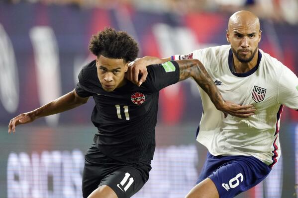 Canada forward Tajon Buchanan (11) and United States defender John Brooks (6) chase down the ball during the second half of a World Cup soccer qualifier Sunday, Sept. 5, 2021, in Nashville, Tenn. (AP Photo/Mark Humphrey)