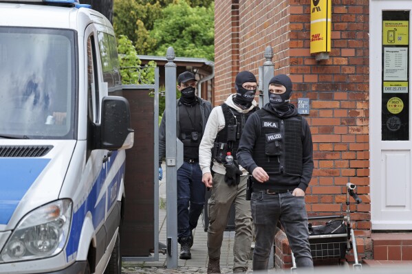 Police search rooms in the 'Altes Postamt' building in Neubukow, Germany, Wednesday, May 21, 2025. (Bernd Wuestneck/dpa via AP)