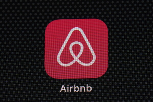 FILE - The Airbnb app icon is displayed on an iPad screen in Washington, D.C., on May 8, 2021. Airbnb reports earnings on Wednesday, Nov. 1, 2023. Short-term rental platform Airbnb has agreed to pay 576 million euros ($621 million) to settle a years-long dispute over unpaid taxes in Italy but said it won’t try to recover the money from its hosts. (AP Photo/Patrick Semansky, File)