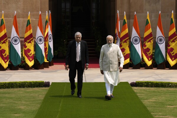 Indian Prime Minister Narendra Modi welcomes Sri Lankan President Ranil Wickremesinghe walk for a photo call before their delegation level meeting in New Delhi, India, Friday, July 21, 2023. (AP Photo/Manish Swarup)