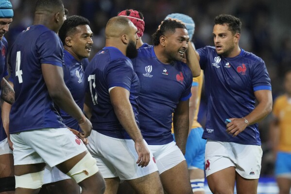France's Peato Mauvaka, second from right, celebrates with teammates after scoring a try during the Rugby World Cup Pool A match between France and Uruguay at the Pierre Mauroy stadium in Villeneuve-d'Ascq, near Lille, France, Thursday, Sept. 14, 2023. (AP Photo/Thibault Camus)