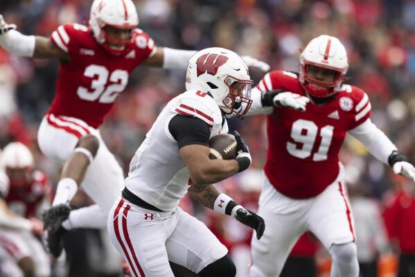 Wisconsin's Braelon Allen, center, carries the ball against Nebraska during the first half of an NCAA college football game Saturday, Nov. 19, 2022, in Lincoln, Neb. (AP Photo/Rebecca S. Gratz)