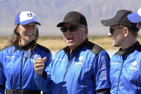 FILE - William Shatner, center, speaks as Audrey Powers, left, and Chris Boshuizen appear during a press availability at the Blue Origin spaceport near Van Horn, Texas, on Oct. 13, 2021. The "Star Trek" actor and the three fellow passengers soared to an altitude of 66.5 miles (107 kilometers) over the West Texas desert in a fully automated capsule, in a flight that lasted just over 10 minutes. (AP Photo/LM Otero, File)