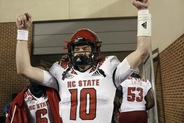 North Carolina State quarterback Ben Finley (10) celebrates as he leaves the field after his team defeated North Carolina in overtime in an NCAA college football game Friday, Nov. 25, 2022, in Chapel Hill, N.C. (AP Photo/Chris Seward)