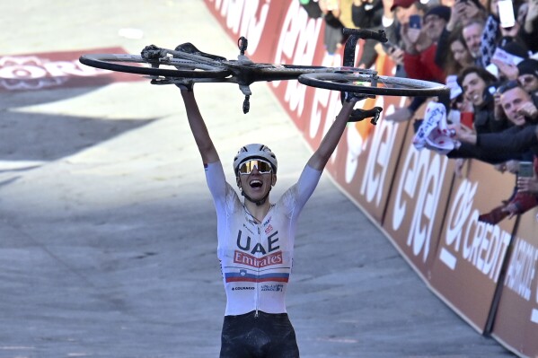 Tadej Pogacar of the UAE Team Emirates celebrates winning the men's 'Strade Bianche' (White Roads) one day cycling race to and from Siena - Tuscany, Italy, Saturday, March 2, 2024. (Gian Mattia D'Alberto/LaPresse via AP)