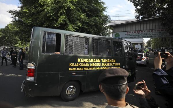 A detention car believed to be carrying firebrand cleric Rizieq Shihab arrives at the East Jakarta District Court ahead of his sentencing hearing, in Jakarta, Indonesia, Thursday, May 27, 2021. Judges are scheduled to deliver their verdict on the trial of Shihab, the leader of now banned Islam Defenders Front, who was accused of inciting people to breach pandemic restrictions by holding events attended by thousands of supporters to commemorate Prophet Muhammad's birthday and the wedding of his daughter in November last year. (AP Photo/Dita Alangkara)