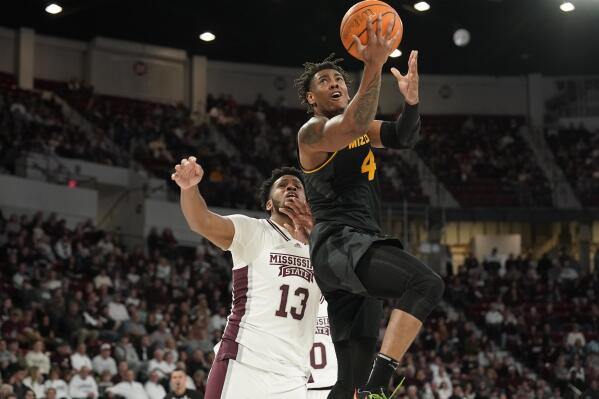 Missouri guard DeAndre Gholston (4) gets past Mississippi State forward Will McNair Jr. (13) on his way to the basket during the first half of an NCAA college basketball game in Starkville, Miss., Saturday, Feb. 4, 2023. (AP Photo/Rogelio V. Solis)