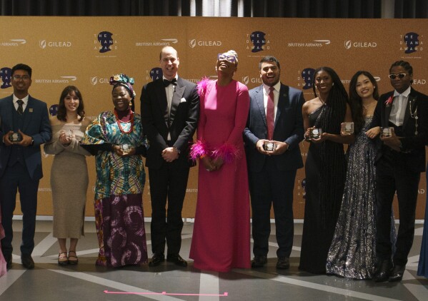 Britain's Prince William poses for a photo with winners, during the Diana Legacy Award, at the Science Museum in London, Thursday, March 14, 2024. (Arthur Edwards/Pool Photo via AP)
