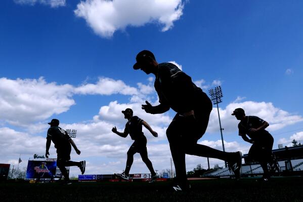 FILE - Quad Cities River Bandits players warm up before a Class-A Midwest League baseball game against the Cedar Rapids Kernels in Cedar Rapids, Iowa, Monday, May 13, 2019. Leaders of the Senate Judiciary Committee have asked baseball Commissioner Rob Manfred to explain the impact of potential legislation stripping the sport’s antitrust exemption from covering the sport’s relationship with minor league players. (AP Photo/Charlie Neibergall, File)