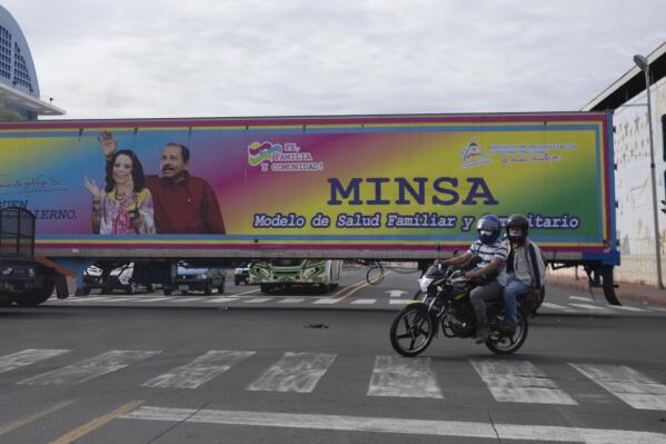 FILE - In this June 17, 2021 file photo, a billboard promoting President Daniel Ortega and his wife and Vice President Rosario Murillo covers a truck driving through Managua, Nicaragua. The U.S. State Department announced Monday, July 12, 2021 it is revoking the travel visas of 100 legislators, judges and prosecutors who aided the regime of President Daniel Ortega. (AP Photo/Miguel Andres, File)