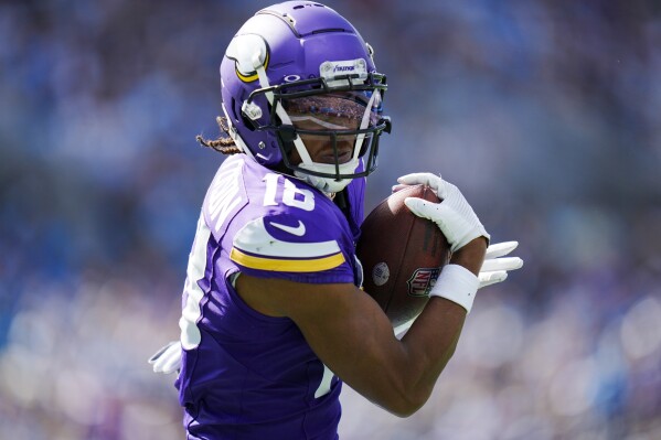 Minnesota Vikings wide receiver Justin Jefferson catches a touchdown pass against the Carolina Panthers during the second half of an NFL football game Sunday, Oct. 1, 2023, in Charlotte, N.C. (AP Photo/Rusty Jones)