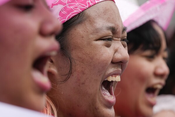 Activists shout slogans during an International Women's Day protest in Manila, Philippines on Friday, March 8, 2024. (AP Photo/Aaron Favila)