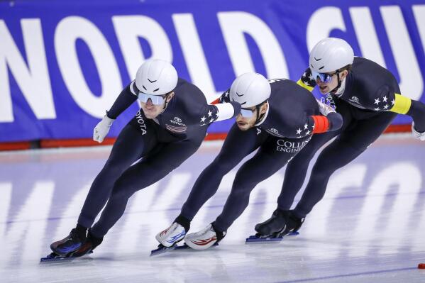 Casey Dawson, left, of the United States, leads teammates Emery Lehman, center, and Ethan Cepuran during the men's team pursuit competition at the ISU World Cup speedskating event in Calgary, Alberta, Sunday, Dec. 12, 2021. (Jeff McIntosh/The Canadian Press via AP)
