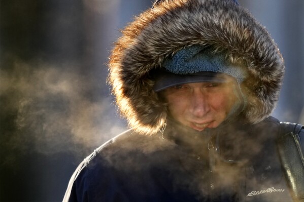 FILE - A passenger disembarks from a ferry arriving from Peaks Island, Feb. 4, 2023, in Portland, Maine. United States winter looks likely to be a bit low on snow and extreme cold outbreaks, with federal forecasters predicting the North to get warmer than normal and the South wetter and stormier, officials at the National Oceanic and Atmospheric Administration said Thursday, Oct. 19, 2023, in releasing their winter outlook. (AP Photo/Robert F. Bukaty, File)