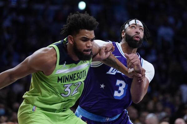 Los Angeles Lakers' Anthony Davis, right, and Minnesota Timberwolves' Karl-Anthony Towns fight for position during the first half of an NBA basketball game Friday, Nov. 12, 2021, in Los Angeles. (AP Photo/Jae C. Hong)