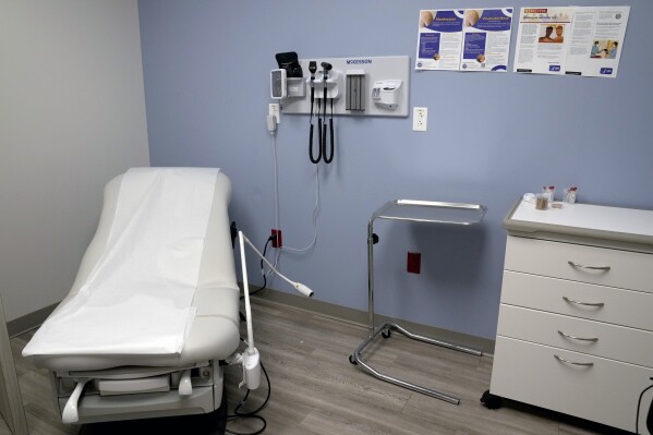 FILE - An exam room is seen inside Planned Parenthood on March 10, 2023. Republican attorneys general from 17 states filed a lawsuit Thursday, April 25, 2024, challenging new federal rules entitling workers to time off and other accommodations for abortions, calling the rules an illegal interpretation of a 2022 federal law. (AP Photo/Jeff Roberson)