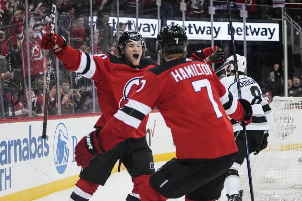 New Jersey Devils' Dawson Mercer (91) celebrates with teammate Dougie Hamilton (7) after scoring the game winning goal during the overtime period of an NHL hockey game against the Los Angeles Kings Thursday, Feb. 23, 2023, in Newark, N.J. The Devils won 4-3.(AP Photo/Frank Franklin II)
