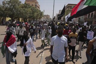 Sudanese protesters rally against the October 2021 military coup which has led to deaths and scores of arrests of demonstrators, in Khartoum, Sudan, Monday, Feb. 28, 2022. Since the coup, more than 80 people, mostly young men, have been killed and over 2,600 others injured in the protests, according to a Sudanese medical group. (AP Photo/Marwan Ali)