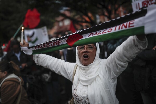 People attend a vigil coined "Palestine Lives," to show support for the Palestinians in the latest Israel-Hamas war, in Bogota, Colombia, Tuesday, Oct. 17, 2023. (AP Photo/Ivan Valencia)