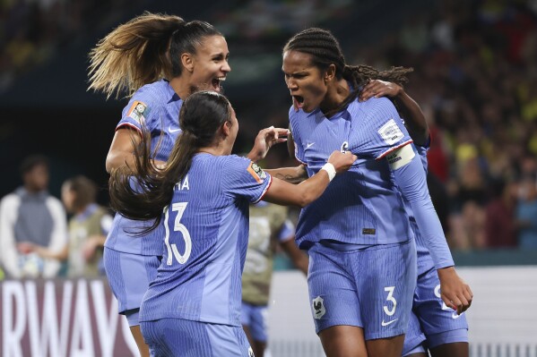 France's Wendie Renard, right, celebrates with teammates after scoring her team's second goal during the Women's World Cup Group F soccer match between France and Brazil in Brisbane, Australia, Saturday, July 29, 2023. (AP Photo/Aisha Schulz)
