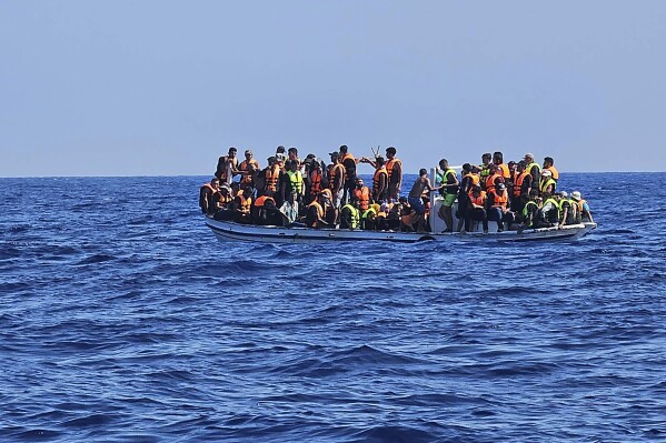 This image provided from Cyprus' Joint rescue Coordination Center shows a boat with migrants in the sea near the eastern coastal resort of Protaras, on the east side of the Mediterranean island of Cyprus, on Sunday, Aug. 21, 2023. Cyprus police have rescued 18 Syrian migrants after their boat started taking on water some 3.5 miles off the southeastern coast. Police said the 11 men, three unescorted minors, one woman and her three children had set sail from Tartus, Syria and were brought ashore aboard a police patrol vessel. (Joint Rescue Coordination Center via AP)