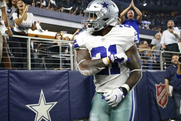 
              Dallas Cowboys running back Ezekiel Elliott (21) celebrates after scoring a touchdown against the New York Giants during the second half of an NFL football game in Arlington, Texas, Sunday, Sept. 16, 2018. (AP Photo/Ron Jenkins)
            