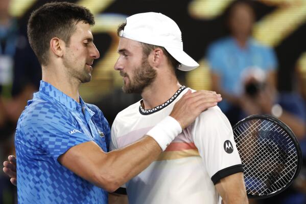 Novak Djokovic, left, of Serbia is congratulated by Tommy Paul of the U.S. after their semifinal at the Australian Open tennis championship in Melbourne, Australia, Friday, Jan. 27, 2023. (AP Photo/Asanka Brendon Ratnayake)