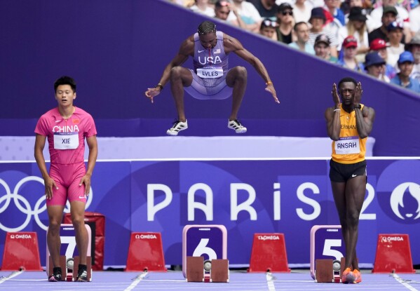 Noah Lyles, of the United States, prepares for a heat in the men's 100-meter at the 2024 Summer Olympics, Saturday, Aug. 3, 2024, in Saint-Denis, France. (AP Photo/Petr David Josek)