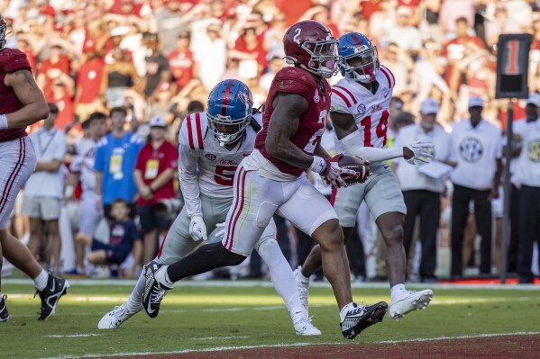 Alabama running back Jase McClellan (2) runs in for a touchdown against Mississippi during the second half of an NCAA college football game, Saturday, Sept. 23, 2023, in Tuscaloosa, Ala. in the background are Mississippi defensive backs John Saunders Jr. (5) and Demarko Williams (14). (AP Photo/Vasha Hunt)