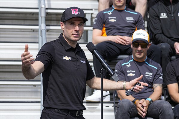 Will Power, of Australia, speaks as Tony Kanaan, of Brazil, looks on during the drivers meeting for the Indianapolis 500 auto race at Indianapolis Motor Speedway in Indianapolis, Saturday, May 27, 2023. (AP Photo/Darron Cummings)