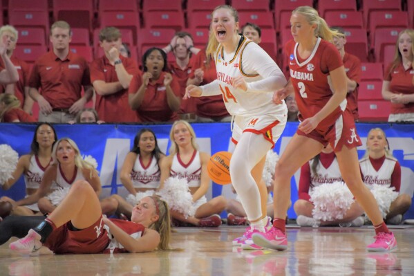 Maryland forward Allie Kubek reacts in front of Alabama guard Chloe Spreen while guard Sarah Ashlee Barker lies on the court after losing the ball and a chance to tie the game in the second round of the NCAA college basketball tournament, Monday, March 24, 2025, in College Park, Md. (Karl Merton Ferron/The Baltimore Sun via AP)