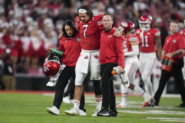 Utah quarterback Cameron Rising (7) is helped off the field during the second half in the Rose Bowl NCAA college football game against Penn State Monday, Jan. 2, 2023, in Pasadena, Calif. (AP Photo/Marcio Jose Sanchez)