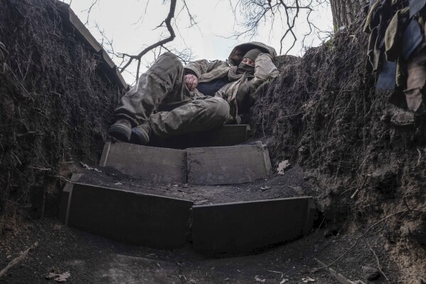 A Ukrainian soldier takes a rest in a trench on the frontline near Liman, Lyman, Donetsk region, Ukraine, Friday, March 29, 2024. (Iryna Rybakova via AP)