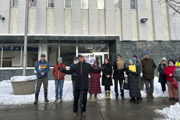 United States Sen. Peter Welch, center, speaks at a rally in Montpelier, Vt., Monday Jan. 8, 2024, demanding that the post office in Vermont's capital city that was hit by catastrophic summer flooding be restored. (AP Photo/Lisa Rathke)