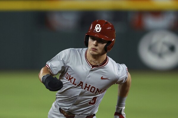 FILE - Oklahoma's John Spikerman (8) runs to third during an NCAA college baseball game against Tennessee Saturday, Feb. 17, 2024, in Arlington, Texas. Oklahoma clinched its first Big 12 regular-season championship with a three-game sweep of Baylor over the weekend. Leadoff man John Spikerman, who missed five weeks following hand surgery, is batting .407 after going 12 for his last 19.(AP Photo/Brandon Wade, File)