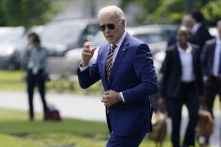 President Joe Biden walks to board Marine One on the Ellipse near the White House grounds, Friday, June 18, 2021, in Washington. (AP Photo/Evan Vucci)