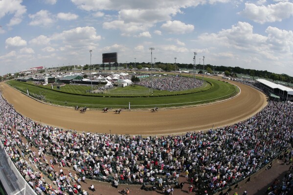FILE - Fans watch a race before the 141st running of the Kentucky Derby horse race at Churchill Downs in Louisville, Ky., May 2, 2015. Racing will resume at Churchill Downs in September 2023 with no changes being made after a review of surfaces and safety protocols in the wake of 12 horse deaths, including seven in the days leading up to the Kentucky Derby in May. (AP Photo/Charlie Riedel, File)