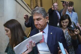 Sen. Joe Manchin, D-W.Va., is surrounded by reporters as he leaves the Senate chamber following a vote, at the Capitol in Washington, Thursday, June 10, 2021. Sen. Manchin is working with a bipartisan group of 10 senators negotiating an infrastructure deal with President Joe Biden. (AP Photo/J. Scott Applewhite)